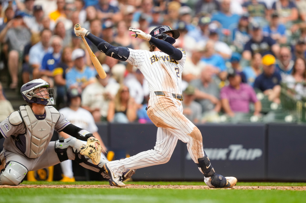 Milwaukee Brewers' Brice Turang, right, watches his home run with Colorado Rockies catcher Hunter Goodman, left, during the sixth inning of a baseball game Friday, July 24, 2026, in Milwaukee. (AP Photo/Kayla Wolf)