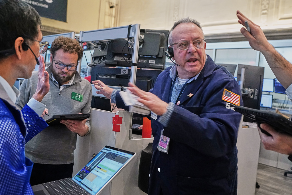 Phil Fracassini, center, works with fellow options traders on the floor of the New York Stock Exchange, Tuesday, Feb. 3, 2026. (AP Photo/Richard Drew)