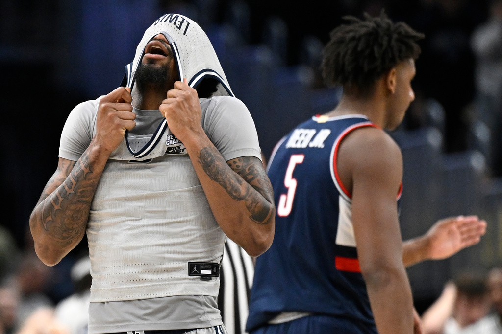 Georgetown Hoyas guard KJ Lewis reacts to missing a three point shot to tie the game in the final seconds during the second half of an NCAA men's basketball game against the UConn Huskies, Saturday, Jan. 17, 2026, in Washington. (AP Photo/John McDonnell)
