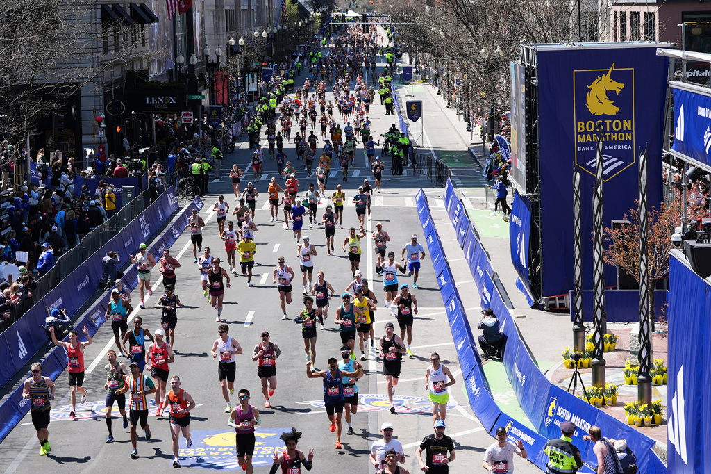 FILE - Runners approach the finish line during the Boston Marathon, April 21, 2025, in Boston. (AP Photo/Charles Krupa, File)