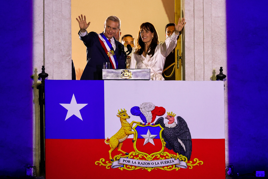 Chile's President Jose Antonio Kast and his wife Maria Pia Adriasola wave to supporters from the balcony of la Moneda presidential palace after his inauguration in Santiago, Chile, Wednesday, March 11, 2026. (AP Photo/Cristobal Basaure)