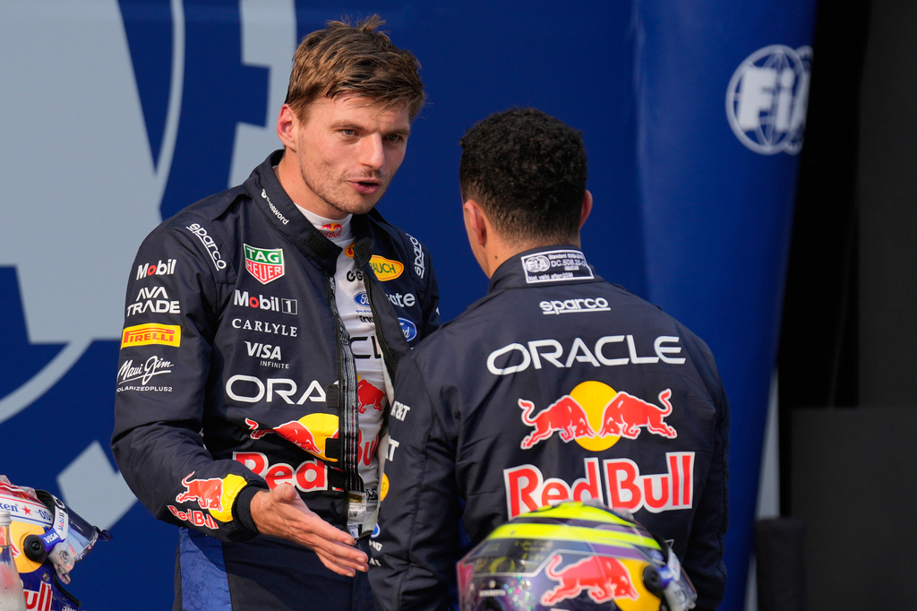 Red Bull driver Max Verstappen of the Netherlands, pole position, talks with his teammate Isack Hadjar of France, third fastest time after the qualifying session ahead of the Bahrain Grand Prix in Sepang, Malaysia, Saturday, Oct. 3, 2026. (AP Photo/Aijaz Rahi)