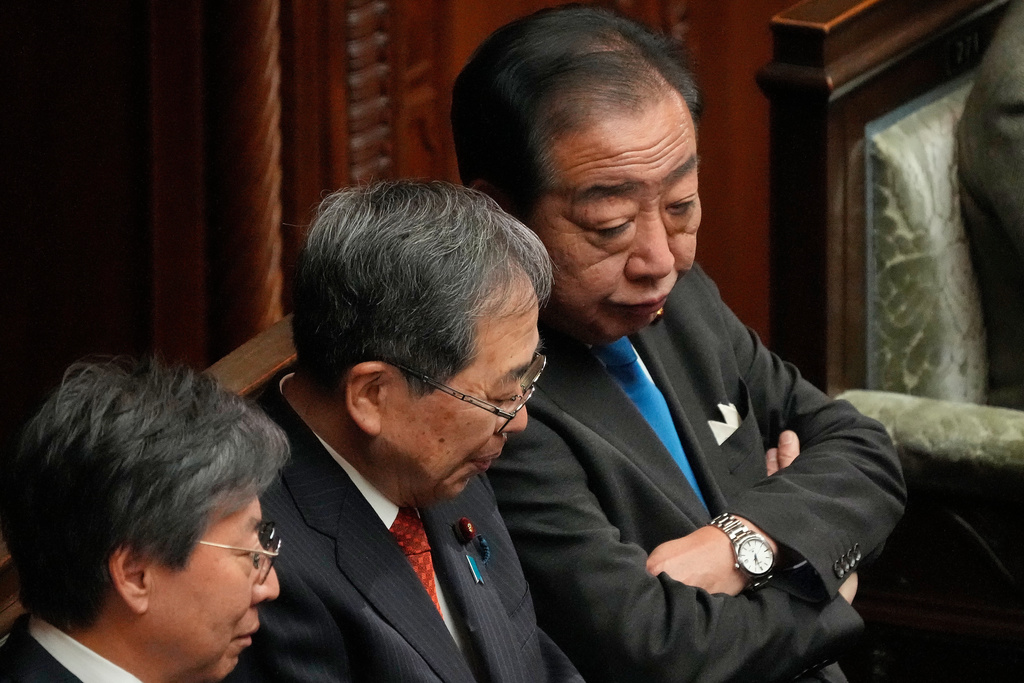 Yoshihiko Noda, right, and Tetsuo Saito, center, of the Centrist Reform Alliance, speak before Prime Minister Sanae Takaichi dissolves the lower house, before an extraordinary Diet session at the lower house of parliament Friday, Jan. 23, 2026, in Tokyo. (AP Photo/Eugene Hoshiko)