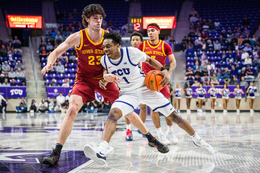 TCU guard Jayden Pierre (1) drives the ball against Iowa State forward Blake Buchanan (23) during an NCAA college basketball game, Tuesday, Feb. 10, 2026, Fort Worth, Texas. (AP Photo/Jessica Tobias)