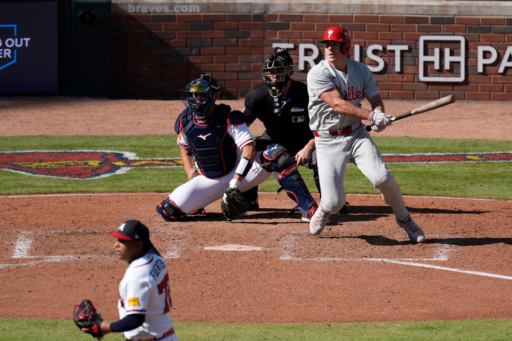 Philadelphia Phillies' J.T. Realmuto hits a two-run triple off Atlanta Braves pitcher Didier Fuentes (72) in the seventh inning during Game 1 of baseball's National League Wild Card Series Tuesday, Sept. 29, 2026, in Atlanta. (AP Photo/Mike Stewart)