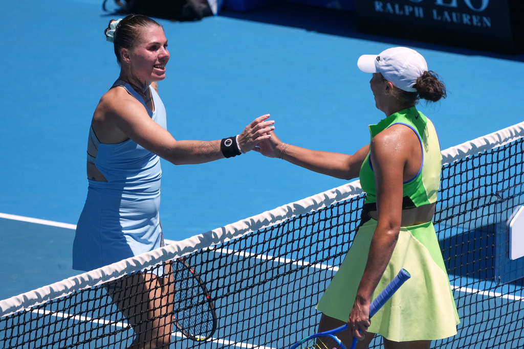 Madison Keys, right, of the U.S. is congratulated by Oleksandra Oliynykova of Ukraine following their first round match at the Australian Open tennis championship in Melbourne, Australia, Tuesday, Jan. 20, 2026. (AP Photo/Asanka Brendon Ratnayake)