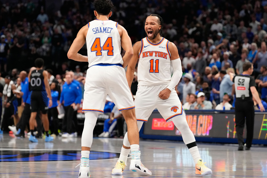 New York Knicks guard Jalen Brunson (11) celebrates with teammate Landry Shamet (44) in the second half of an NBA basketball game against the Dallas Mavericks Wednesday, Nov. 19, 2025, in Dallas. (AP Photo/Tony Gutierrez)