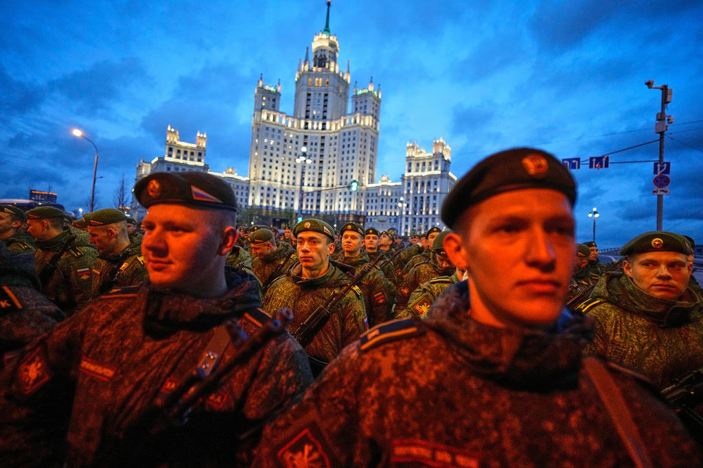 Russian servicemen prepare to march towards Red Square prior to the Victory Day military parade rehearsal in Moscow, Wednesday, April 29, 2026, backdropped by a Stalin stile skyscraper. (AP Photo/Alexander Zemlianichenko)