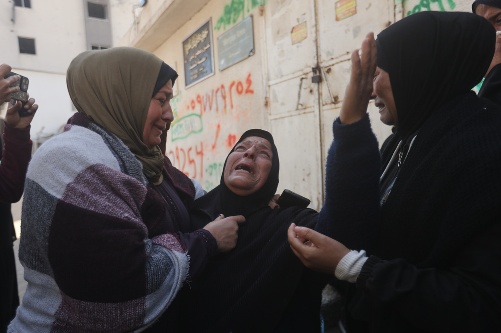 Palestinians mourn over people killed in an Israeli strike during their funeral at Al-Shifa Hospital in Gaza City Saturday, April 25, 2026. (AP Photo/Yousef Alzanoun)