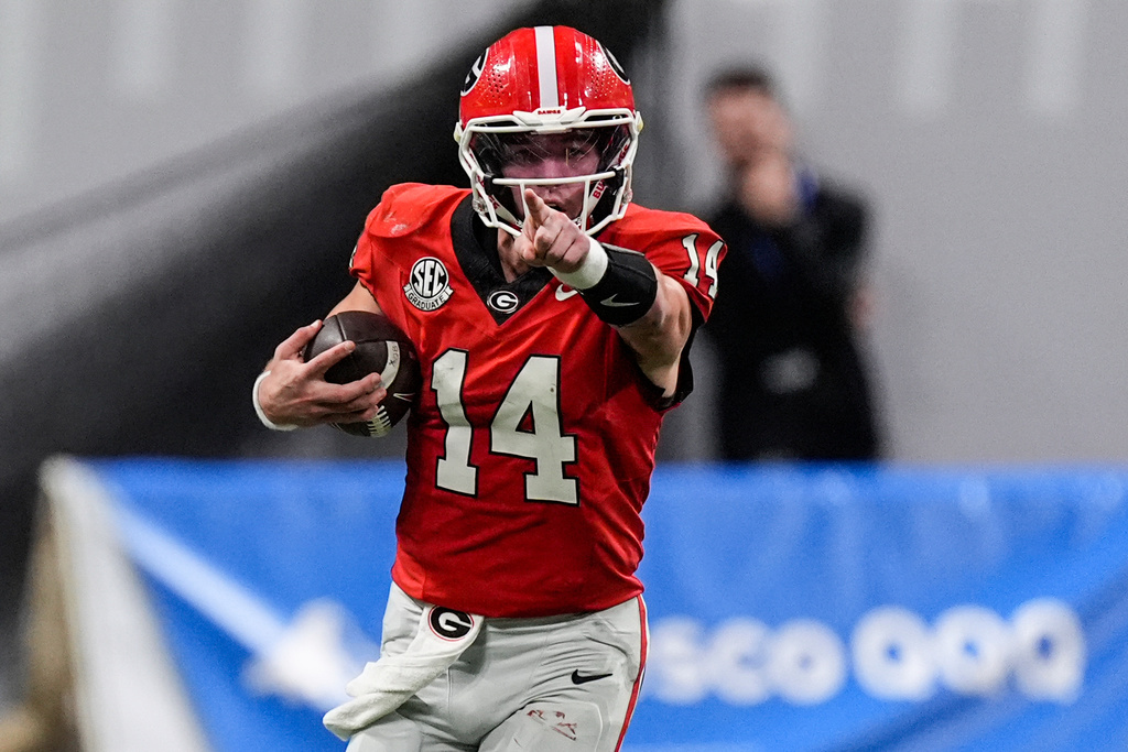 Georgia quarterback Gunner Stockton (14) runs out of the pocket against Georgia Tech during the second half of an NCAA college football game, Friday, Nov. 28, 2025, in Atlanta. (AP Photo/Mike Stewart)