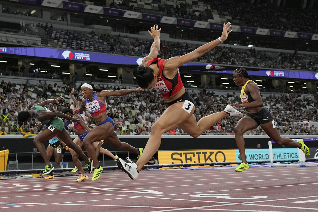 Switzerland's Ditaji Kambundji (3) wins the the women's 100 meters hurdles final at the World Athletics Championships in Tokyo, Monday, Sept. 15, 2025. (AP Photo/David J. Phillip)