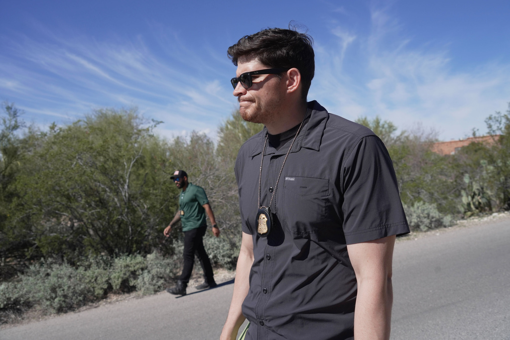 Law enforcement agents check vegetation areas around Nancy Guthrie’s home in Tucson, Ariz., Wednesday, Feb. 11, 2026. (AP Photo/Ty ONeil)