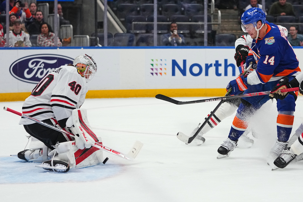 Chicago Blackhawks goaltender Arvid Soderblom (40) stops a shot by New York Islanders' Bo Horvat (14) during the second period of an NHL hockey game Thursday, Oct. 8, 2026, in Elmont, N.Y. (AP Photo/Frank Franklin II)