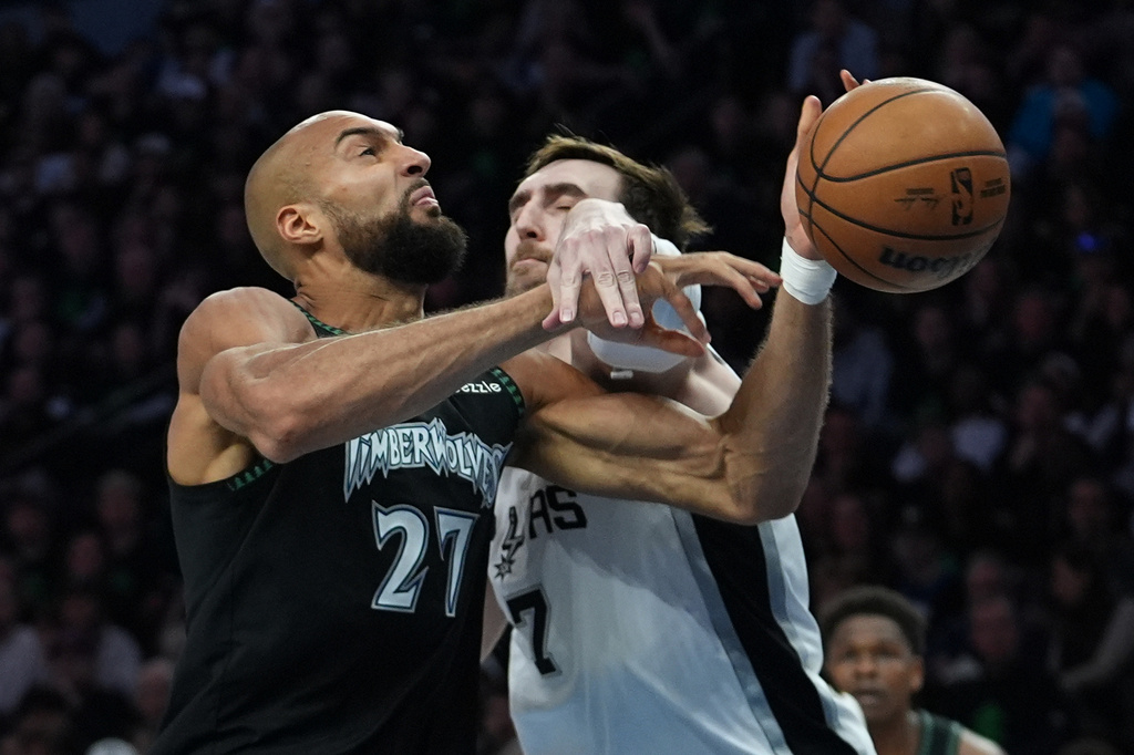 Minnesota Timberwolves center Rudy Gobert (27) is fouled as he drives to the basket against San Antonio Spurs center Luke Kornet (7) during the first half of Game 4 of an NBA basketball second-round playoffs series in Minneapolis, Sunday, May 10, 2026. (AP Photo/Abbie Parr)