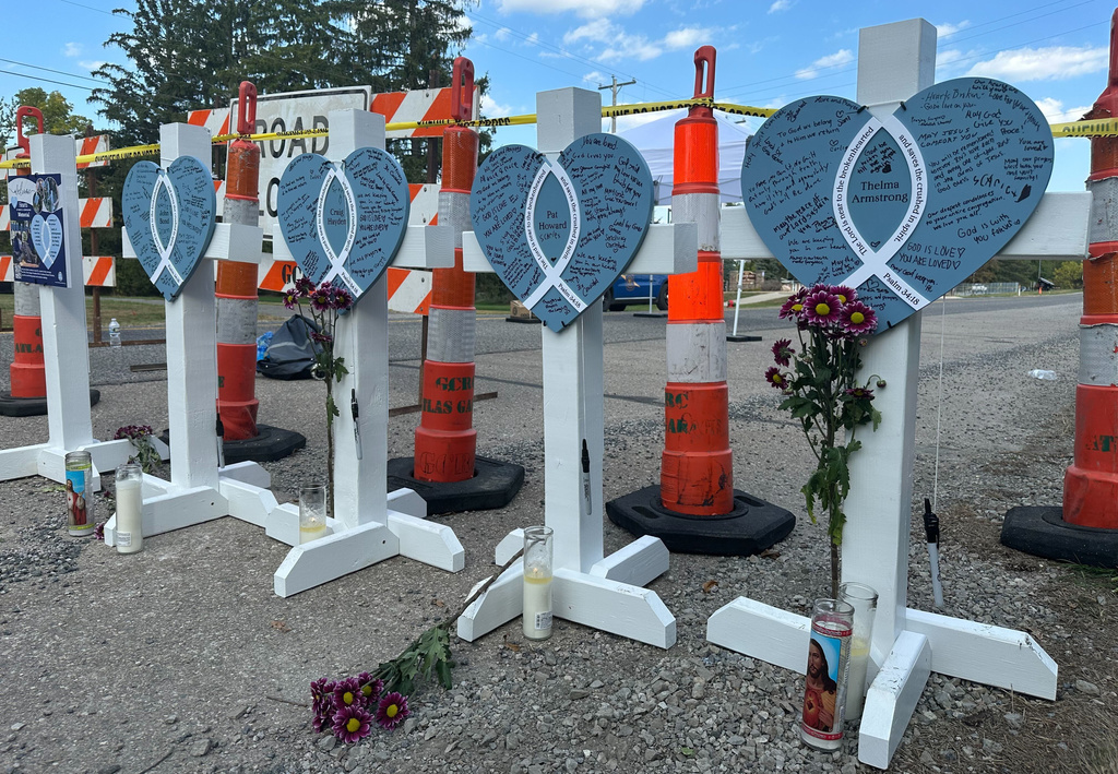 Crosses, in memory of the four people killed when a man rammed his vehicle into the church before opening fire and setting the building ablaze, stand near the Church of Jesus Christ of Latter-day Saints in Grand Blanc Township, Mich., on Friday, Oct. 3, 2025. (AP Photo/Isabella Volmert)