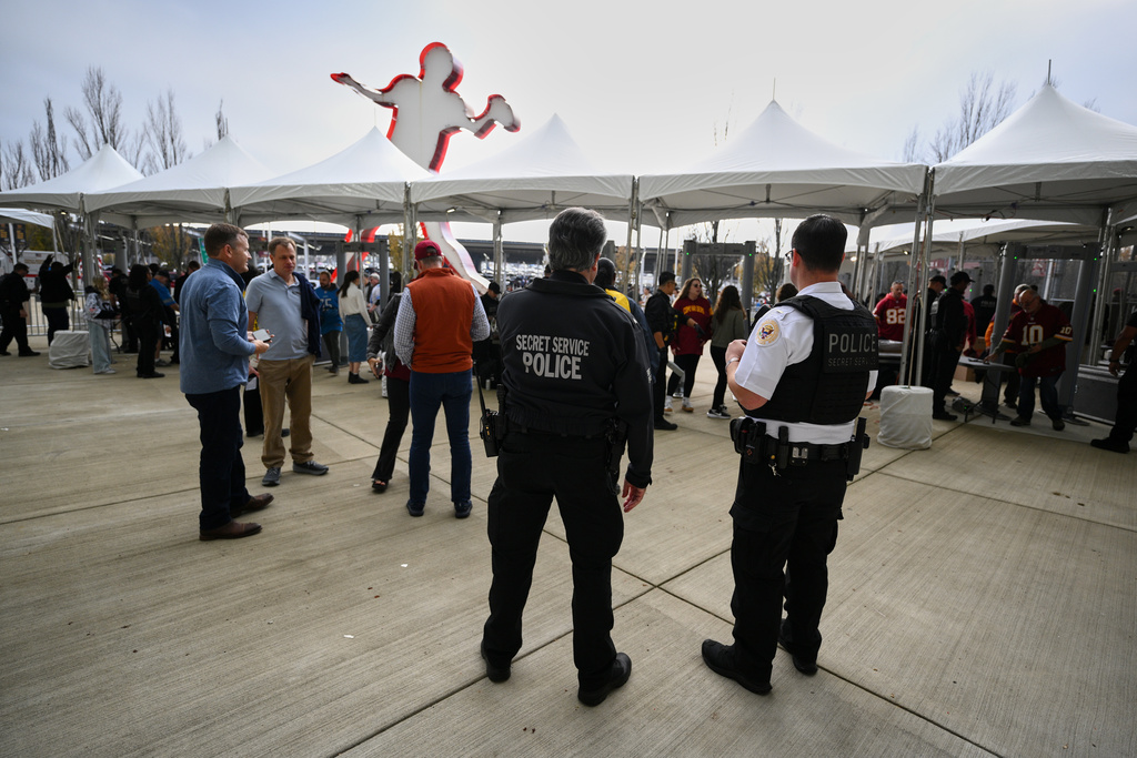 Fans enter through a security checkpoint before an NFL football game between the Washington Commanders and the Detroit Lions Sunday, Nov. 9, 2025, in Landover, Md. (AP Photo/Nick Wass)