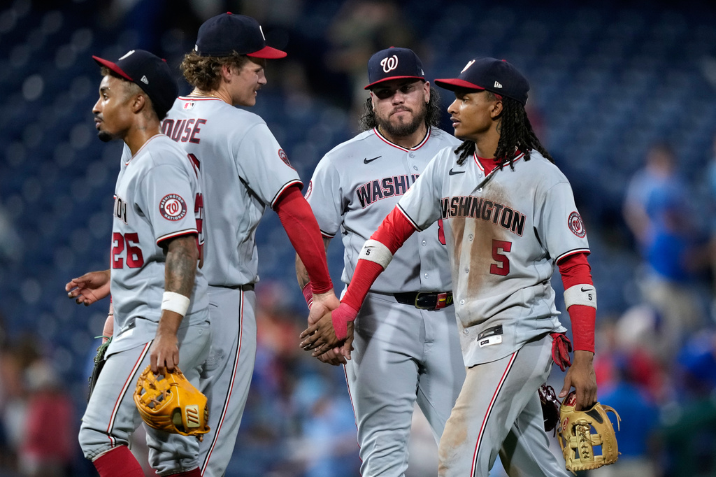 Washington Nationals' Nasim Nuñez, from left, Brady House, Andrés Chaparro and CJ Abrams celebrate after the Nationals won a baseball game against the Philadelphia Phillies in 1 innings Wednesday, Aug. 5, 2026, in Philadelphia. (AP Photo/Matt Slocum)
