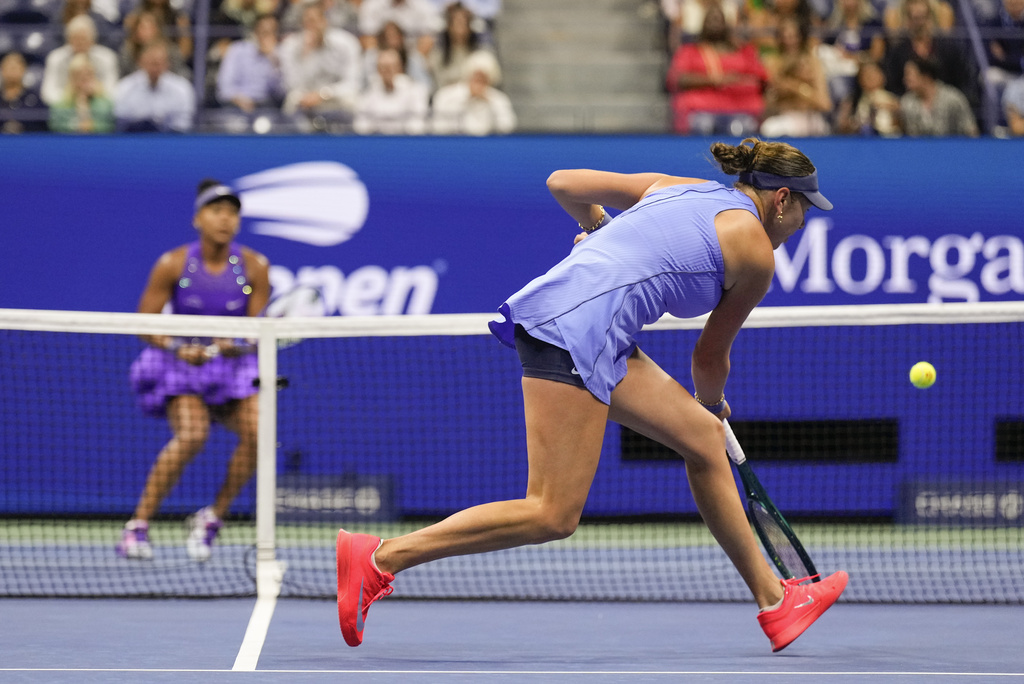 Amanda Anisimova, of the United States, returns a shot to Naomi Osaka, of Japan, during the women's singles semifinals of the U.S. Open tennis championships, Thursday, Sept. 4, 2025, in New York. (AP Photo/Seth Wenig)