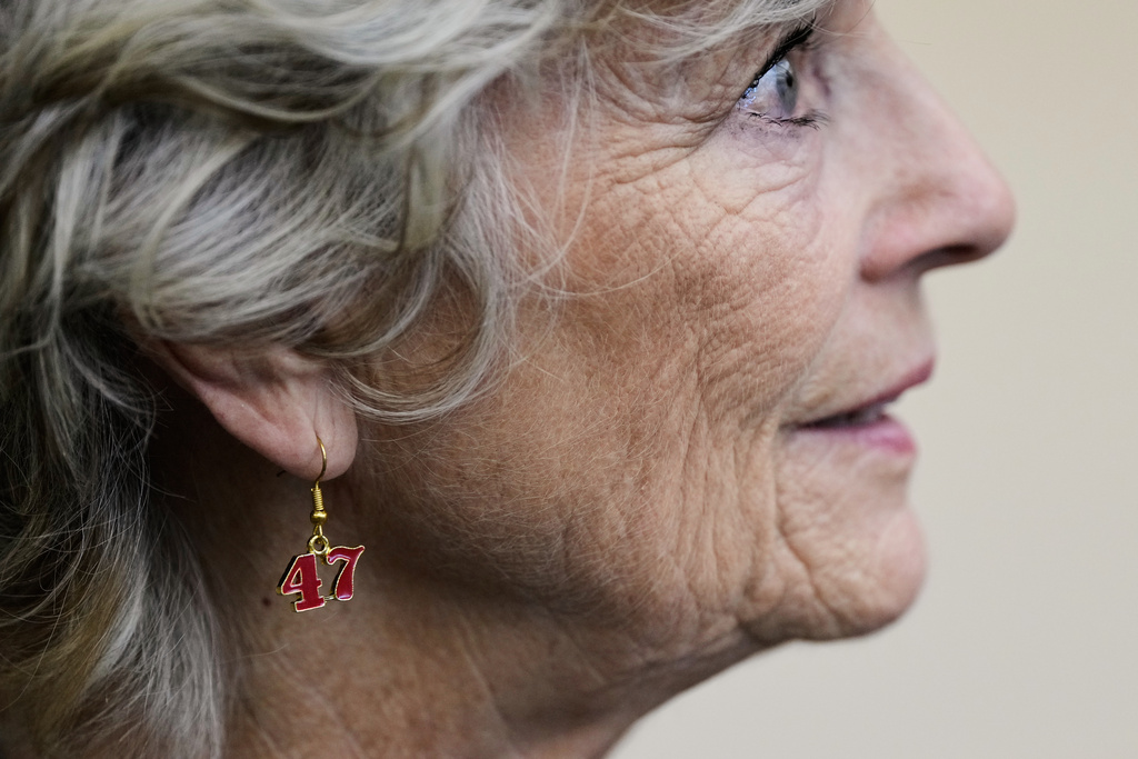 Brenda Haynes wears earrings to show her support of President Donald Trump during a No on Prop 50 rally, Tuesday, Oct. 21, 2025, in Redding, Calif. (AP Photo/Godofredo A. Vásquez)