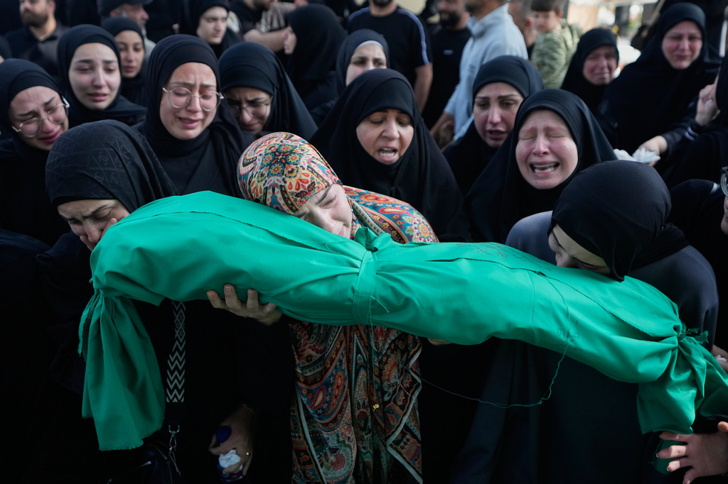 Women grieve as they carry the body of 6-month-old Mariam Fahos during a funeral procession for people killed a day earlier in an Israeli airstrike in the village of Saksakieh, in the southern port city of Sidon, Lebanon, Sunday, May 10, 2026. (AP Photo/Mohammed Zaatari)
