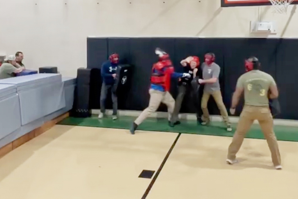 In this still image from video obtained by The Associated Press, Heather Sterling is hit by one of her instructors, who is acting as a violent assailant, during a four-on-one training drill, Dec. 13, 2024, at the Texas Game Warden Training Center in Hamilton, Texas.