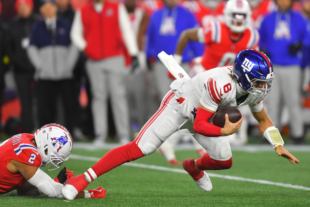 New York Giants quarterback Jaxson Dart (6) is sacked by New England Patriots linebacker Harold Landry III (2) during the second half of an NFL football game Monday, Dec. 1, 2025, in Foxborough, Mass. (AP Photo/Steven Senne)