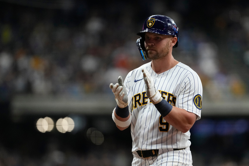 Milwaukee Brewers' Jake Bauers claps after hitting a two-run single during the fifth inning of a baseball game against the Cincinnati Reds, Saturday, Sept. 12, 2026, in Milwaukee. (AP Photo/Aaron Gash)