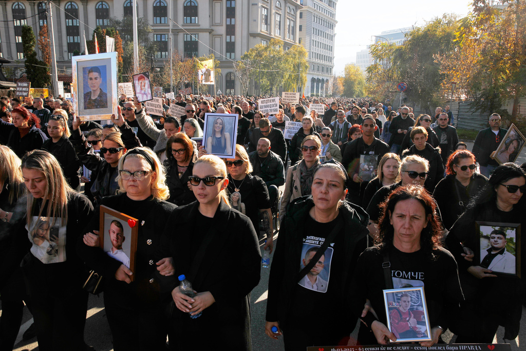 Relatives protest carrying pictures of the Kocani nightclub fire victims, a fire that killed 63 people, while marching in Skopje, North Macedonia, on Saturday, Nov. 15, 2025, just a few days before the start of the trial for the fire. (AP Photo/Boris Grdanoski)