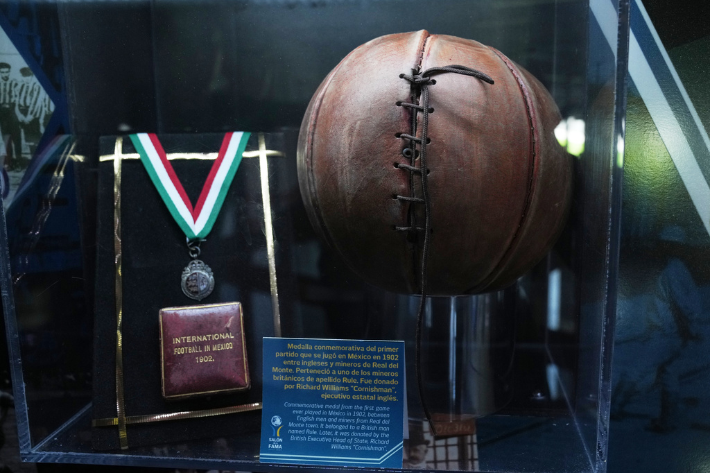 A soccer ball and a medal from 1902 are on display at the Football Museum in Pachuca, Hidalgo state, Mexico, Thursday, May 14, 2026. (AP Photo/Marco Ugarte)