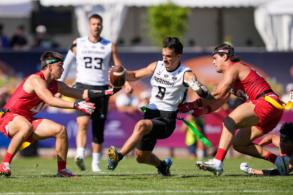 Germany's Malik Al-Kahlout runs with the ball during the Flag Football World Championship men's match between Mexico and Germany in Duesseldorf, Germany, Thursday, Aug. 13, 2026. (AP Photo/Martin Meissner)