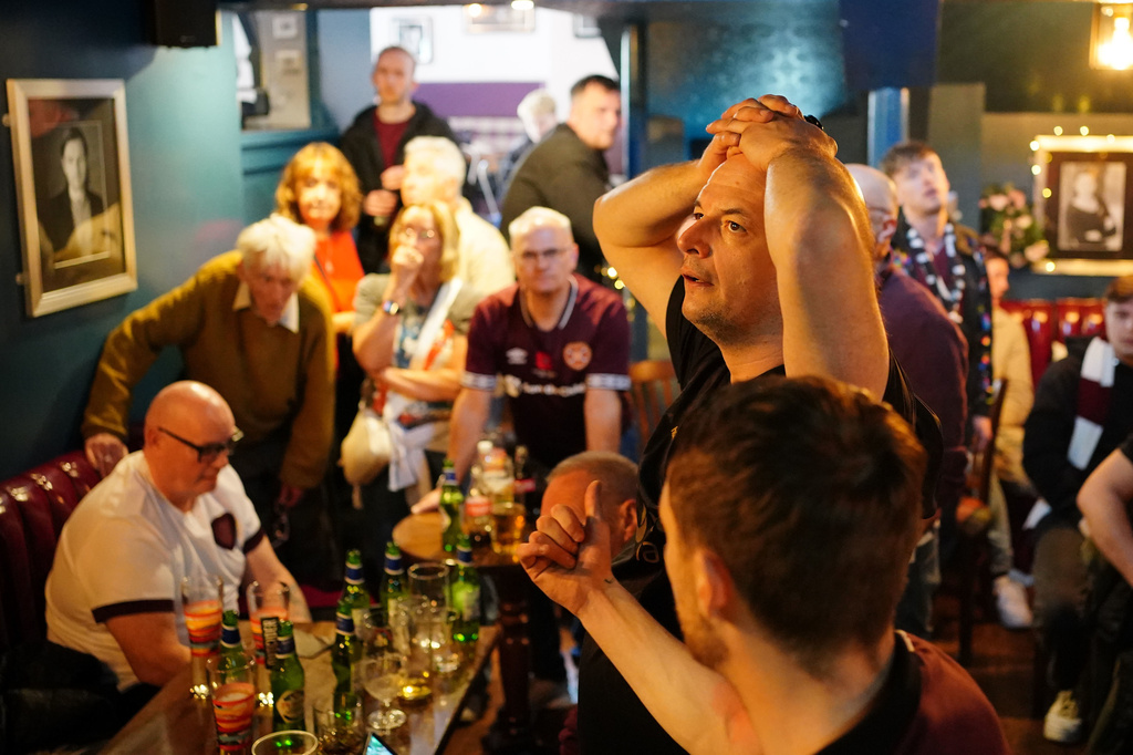 Heart of Midlothian fans show dejection as they watch the Scottish Premier League championship decider against Celtic, at Etore's bar near the stadium in Edinburgh, Scotland, Saturday May 16, 2026. (Jane Barlow/PA via AP)