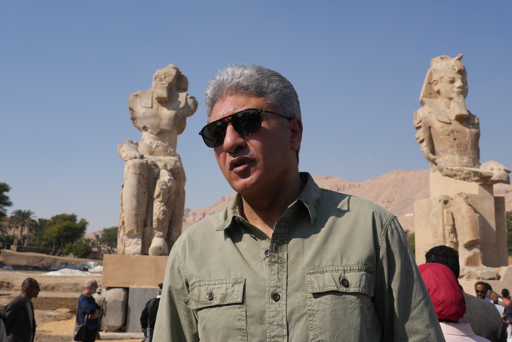 Minister of Tourism and Antiquities Sherif Fathy speaks in front of the two giant reassembled alabaster statues of Pharoah Amenhotep III, in the southern city of Luxor, Egypt, Sunday, Dec. 14, 2025. (AP Photo/Amr Nabil)