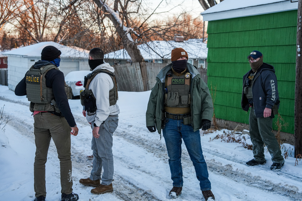 Federal agents conduct immigration enforcement operations in a neighborhood on Monday, Feb. 2, 2026, in Minneapolis. (AP Photo/Ryan Murphy)