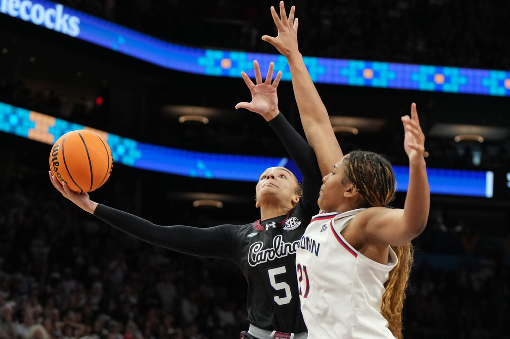 South Carolina guard Tessa Johnson (5) shoots over UConn forward Sarah Strong (21) during the second half of a woman's NCAA college basketball tournament semifinal game at the Final Four, Friday, April 3, 2026, in Phoenix. (AP Photo/Rick Scuteri)