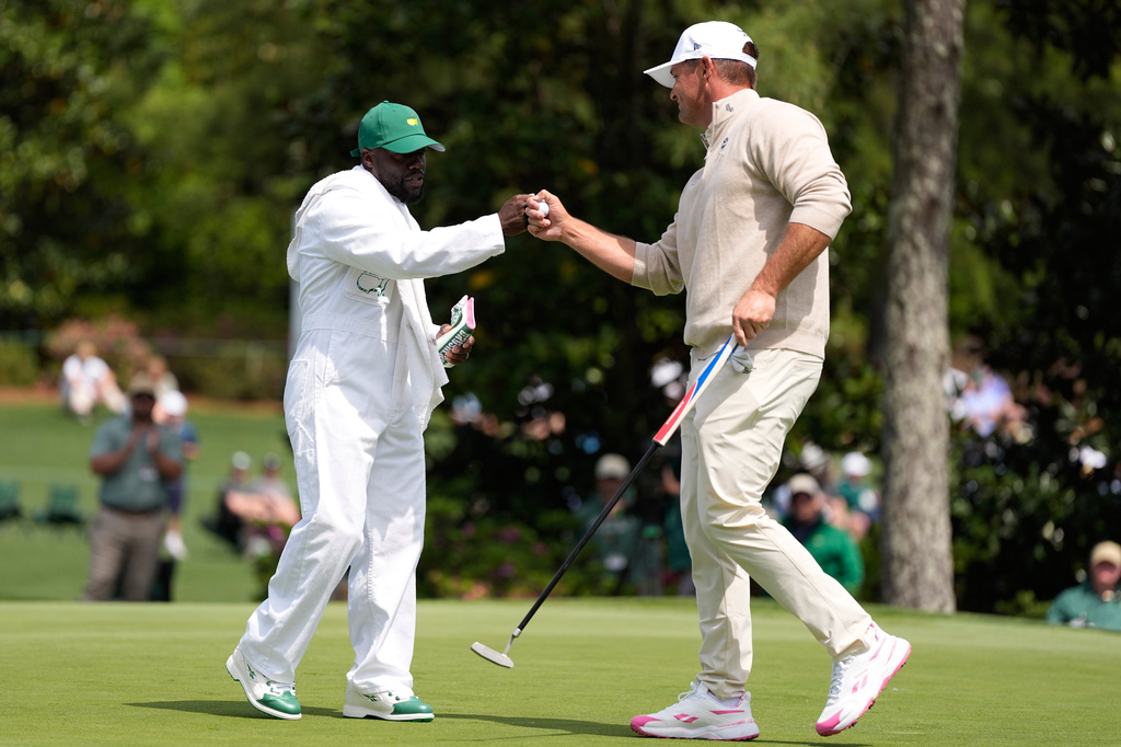 Actor Kevin Hart, left, celebrates with Bryson DeChambeau on the third hole during par-3 contest ahead of the Masters golf tournament at the Augusta National Golf Club, Wednesday, April 8, 2026, in Augusta, Ga. (AP Photo/Ashley Landis)
