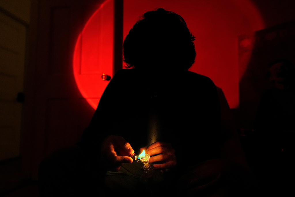 Kyle, a college student, smokes cannabis out of a bong, Oct. 29, 2025, in Boston. (AP Photo/Robert F. Bukaty)