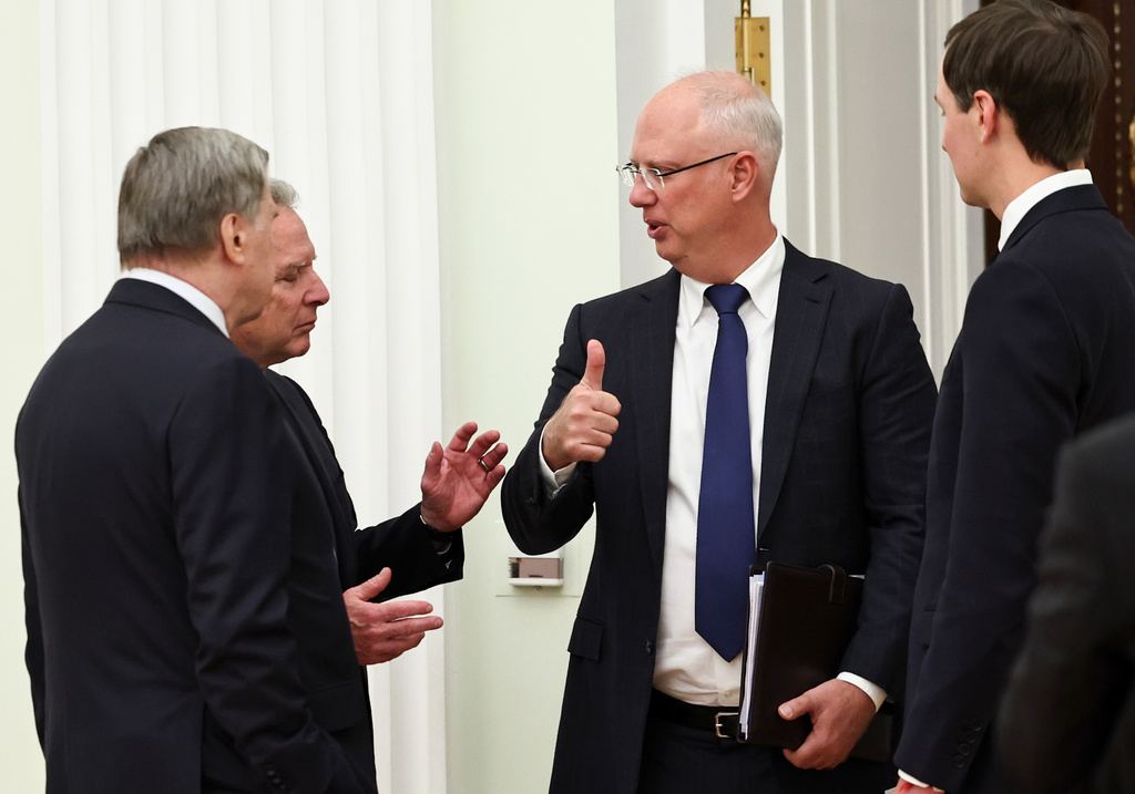 Kremlin foreign policy adviser Yuri Ushakov, left, U.S. President Donald Trump's envoy Steve Witkoff, second left, Putin's envoy Kirill Dmitriev, second right, and Trump's envoy Jared Kushner talk to each other prior to their meeting with Russian President Vladimir Putin at the Senate Palace of the Kremlin, in Moscow, Thursday, Jan. 22, 2026. (Alexander Kazakov/Sputnik, Kremlin Pool Photo via AP)