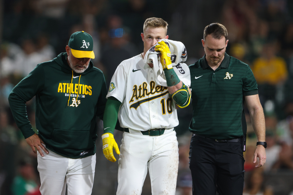 Athletics' Brian Serven, middle, walks off the field after being hit in the eye when he fouled off a bunt during the sixth inning of a baseball game against the Los Angeles Angels Wednesday, Sept. 23, 2026, in West Sacramento, Calif. (AP Photo/Scott Marshall) CORRECTION : Corrects to being hit in the eye when he fouled off a bunt instead of being hit by a pitch.