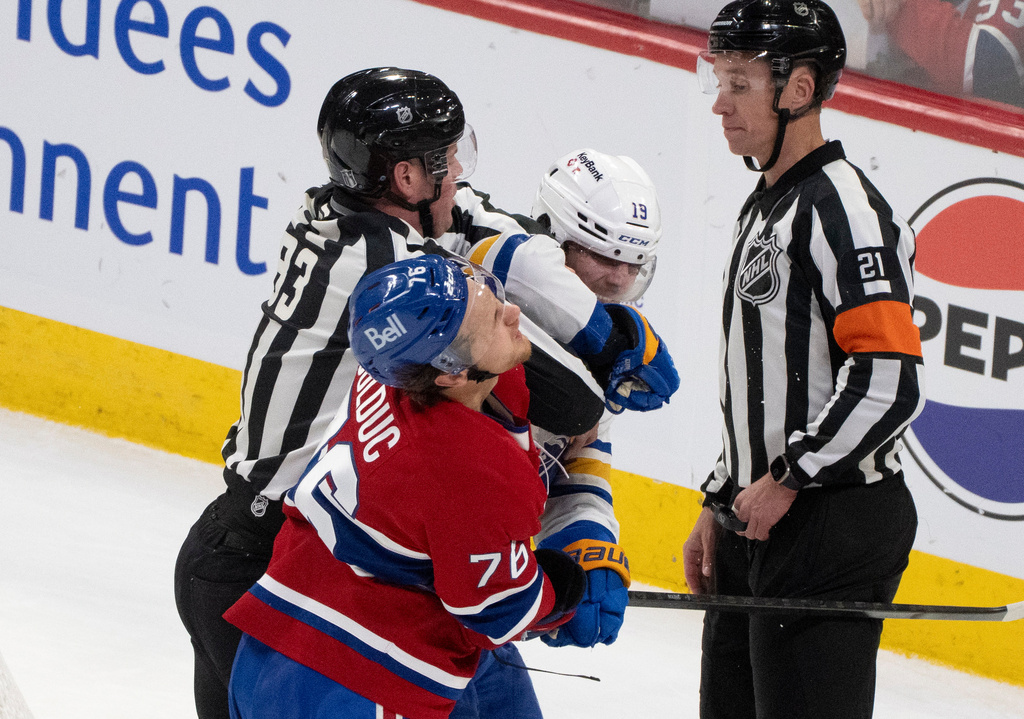 Montreal Canadiens' Zachary Bolduc (76) and Buffalo Sabres' Peyton Krebs (19) fight during the first period in Game 4 of a second-round NHL hockey playoff game in Montreal on Tuesday, May 12, 2026. (Christinne Muschi/The Canadian Press via AP)