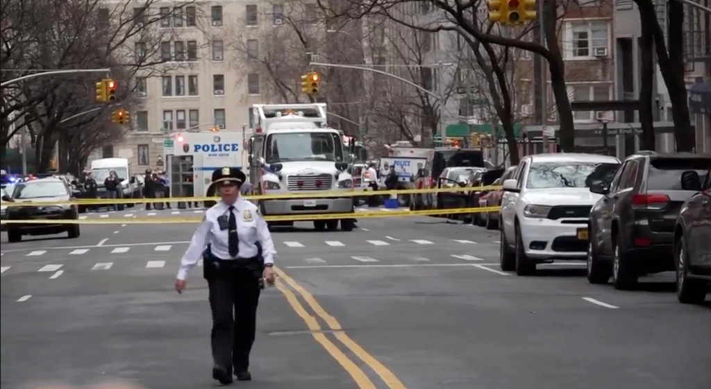 In this image taken from video, law enforcement officers respond to Manhattan's Upper East Side as New York City's police said they had identified a "suspicious device in a vehicle,” Sunday, March 8, 2026, in New York. (AP Photo/Joseph B. Frederick)