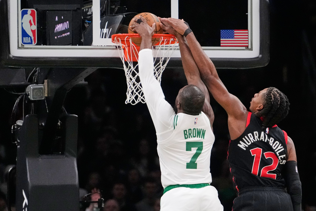 Boston Celtics guard Jaylen Brown (7) dunks against Toronto Raptors forward Collin Murray-Boyles (12) during the first half of an NBA basketball game, Friday, Jan. 9, 2026, in Boston. (AP Photo/Charles Krupa)