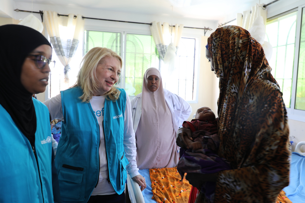 UNICEF Executive Director Catherine Russell (center) listens to a woman holding her malnourished child at Dolow Referral Hospital in southern Somalia after being affected by drought, Wednesday, March 25, 2026. (AP Photo/Mohamed Sheikh Nor)