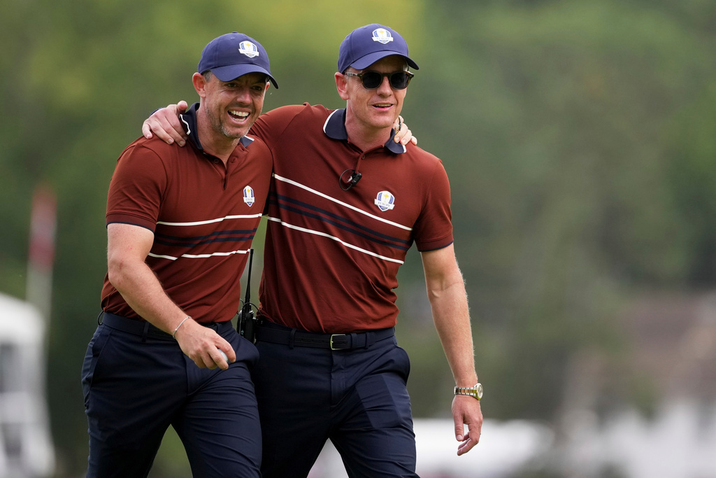 Europe captain Luke Donald and Rory McIlroy celebrates after a putt on the 15th hole at Bethpage Black golf course during the Ryder Cup golf tournament, Saturday, Sept. 27, 2025, in Farmingdale, N.Y. (AP Photo/Matt Slocum)