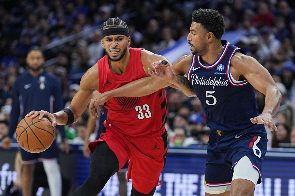 Portland Trail Blazers' Toumani Camara tries to get past Philadelphia 76ers' Quentin Grimes during the first half of an NBA basketball game Sunday, March 15, 2026, in Philadelphia. (AP Photo/Matt Rourke)
