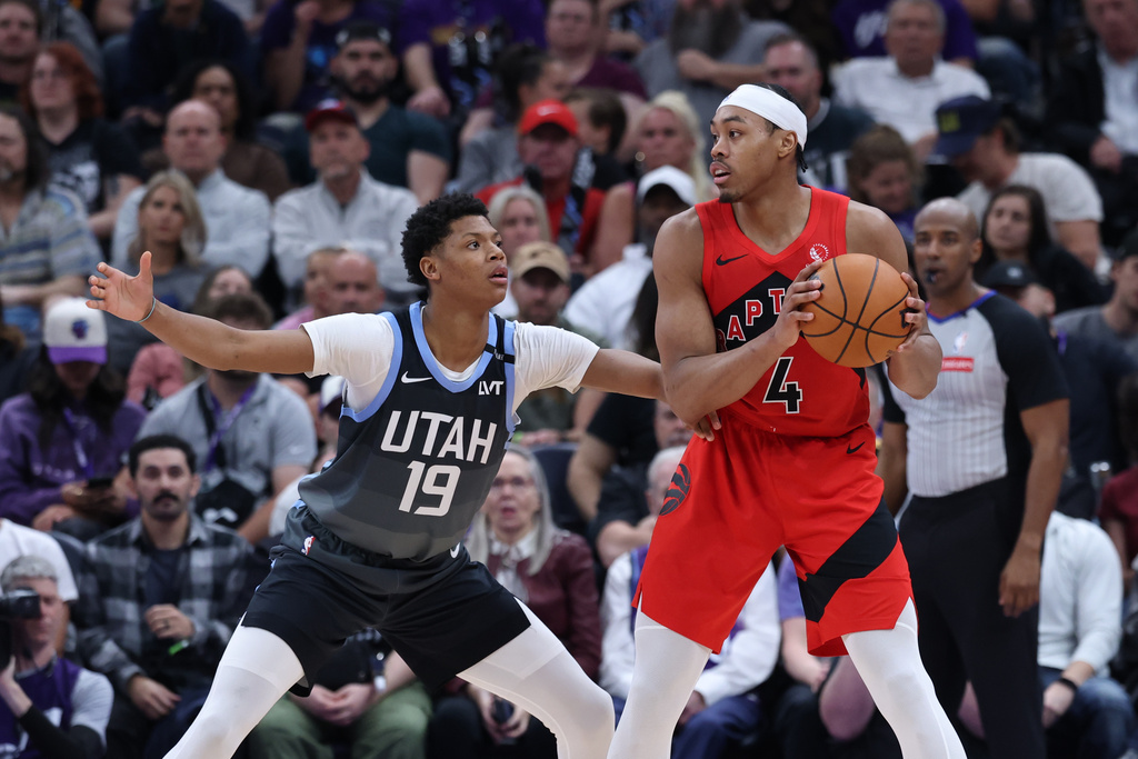 Toronto Raptors forward Scottie Barnes (4) looks for a play as Utah Jazz guard Ace Bailey (19) defends during the first half of an NBA basketball game, Monday, March 23, 2026, in Salt Lake City. (AP Photo/Rob Gray)