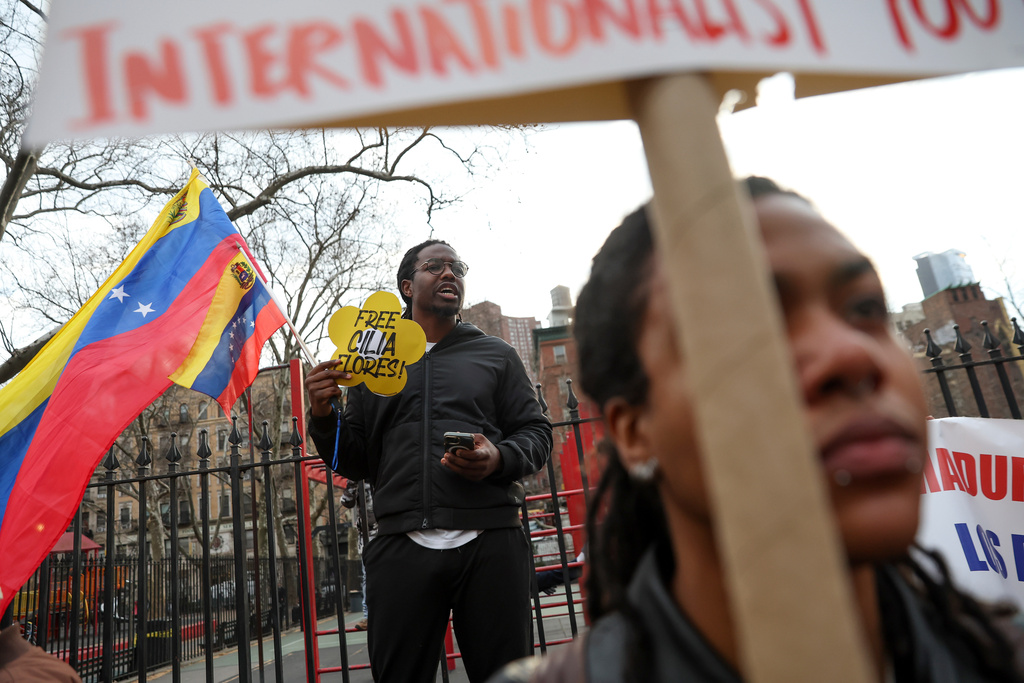Demonstrators protest outside Manhattan federal court before a pre-trial hearing in former Venezuela President Nicolas Maduro's drug trafficking case, Thursday, March 26, 2026, in New York. (AP Photo/Heather Khalifa)