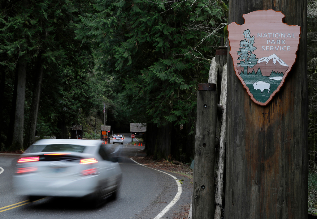FILE - A car drives past the Nisqually entrance to Mount Rainier National Park on Jan. 28, 2019, in Washington state. (AP Photo/Ted S. Warren, File)
