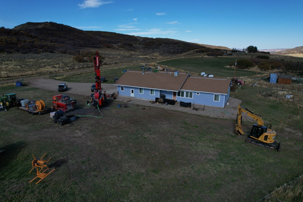 A drill sits outside the Cooper family ranch as they work to install a geothermal heat pump Thursday, Oct. 9, 2025, in Hamilton, Colo. (AP Photo/Brittany Peterson)