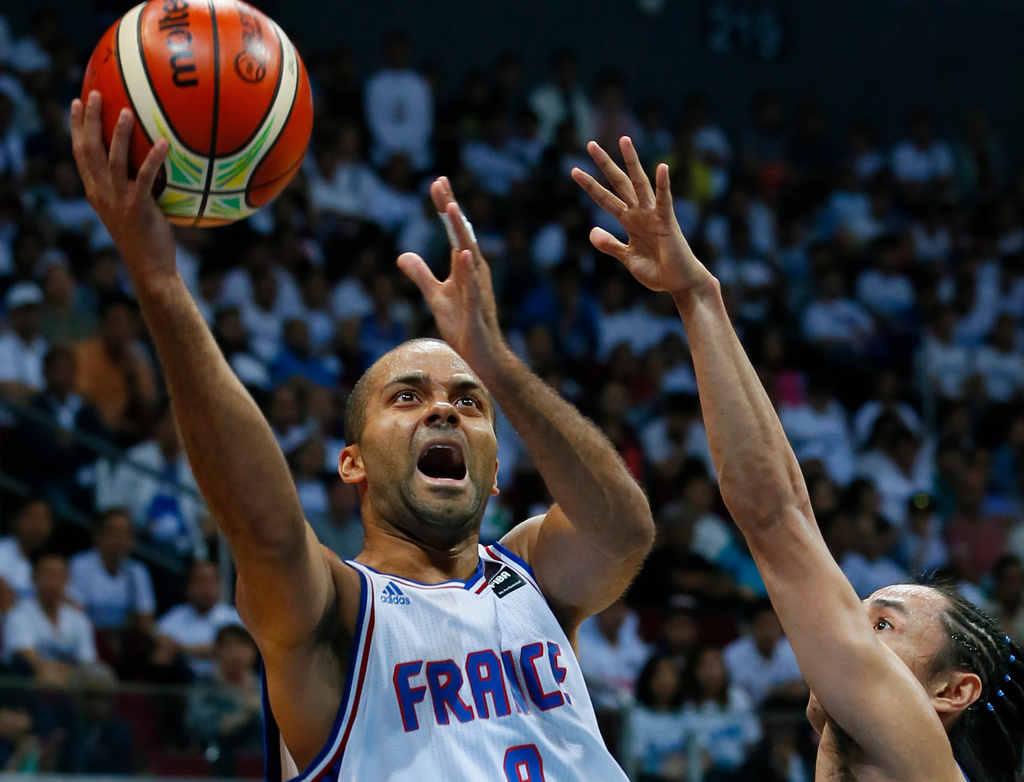 FILE - Tony Parker of France shoots the ball over the Philippines' Jeff Chan during the Group B FIBA Olympics Qualifying basketball match Tuesday, July 5, 2016 in suburban Pasay city south of Manila, Philippines. France won 93-84.(AP Photo/Bullit Marquez, file)