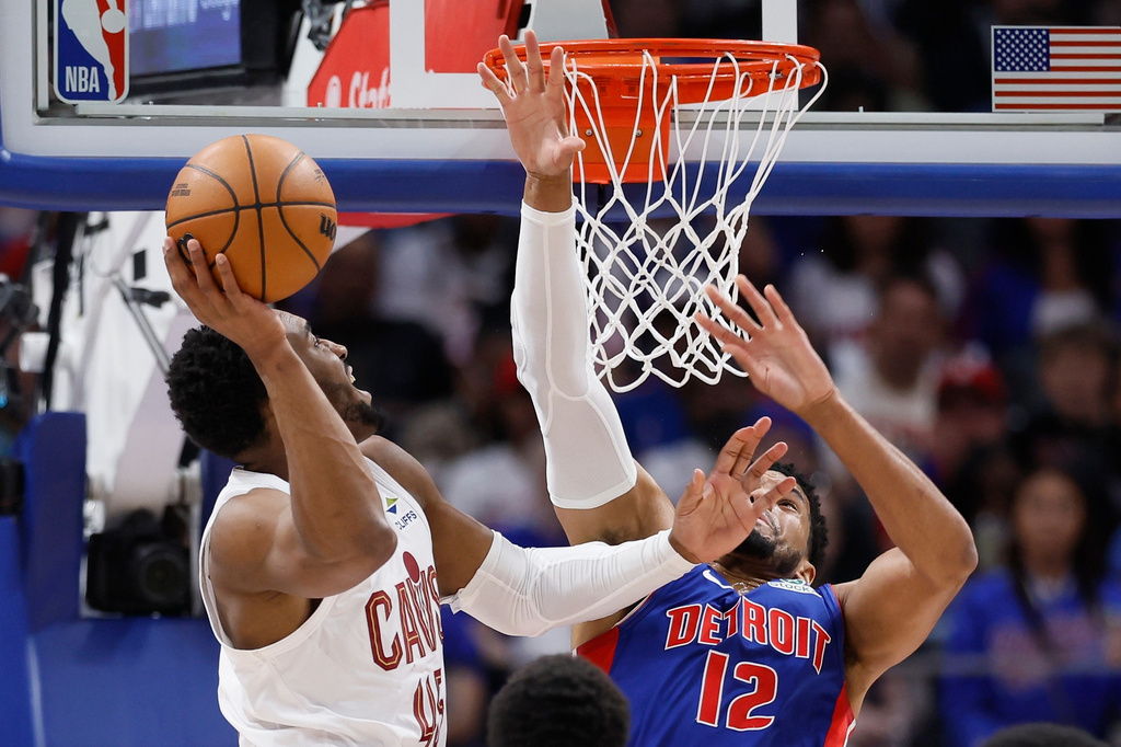Cleveland Cavaliers guard Donovan Mitchell goes to the basket against Detroit Pistons forward Tobias Harris (12) during the first half of Game 7 in a second-round NBA playoffs basketball series, Sunday, May 17, 2026, in Detroit. (AP Photo/Duane Burleson)